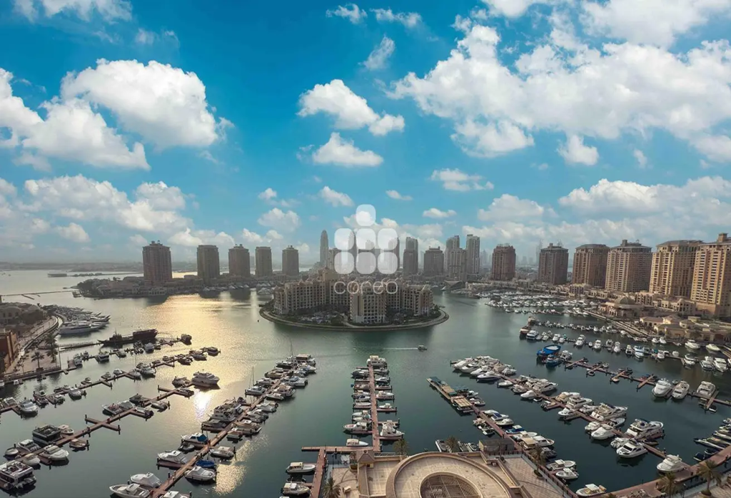 View of The Pearl Island's Marina from a balcony in Porto Arabia Tower 23 showing water and boats